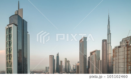 Aerial view of Dubai Downtown skyline with many towers day to night timelapse. Aerial view of Dubai Downtown skyline with many towers day to night timelapse. 105102460