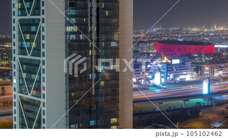 Aerial view to Dubai City Walk district night timelapse behind skyscraper from above 105102462