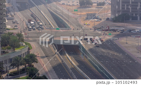 Top aerial view of busy road intersection and traffic junctions in Dubai city timelapse. 105102493