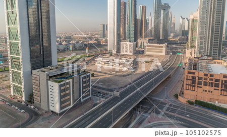 Many towers and skyscrapers with traffic on streets in Dubai Downtown and financial district timelapse. Many towers and skyscrapers with traffic on streets in Dubai Downtown and financial district timelapse. 105102575