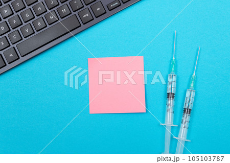 Vaccination or Revaccination Concept - Two Medical Syringe on Blue Table 105103787