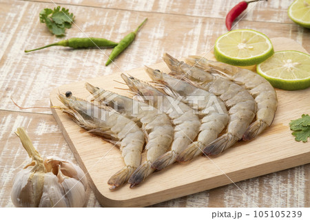 Fresh raw shrimp (Litopenaeus vannamei) on wooden plate.with copy space Fresh raw shrimp (Litopenaeus vannamei) on wooden plate.with copy space 105105239