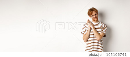 Cunning redhead man having plan, rubbing palms and looking devious at camera, smirk and squint sly, standing over white background Cunning redhead man having plan, rubbing palms and looking devious at camera, smirk and squint sly, standing over white background 105106741