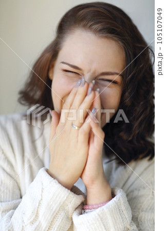 Close up portrait of young funny brunette girl laughing hard on some joke Close up portrait of young funny brunette girl laughing hard on some joke 105107049