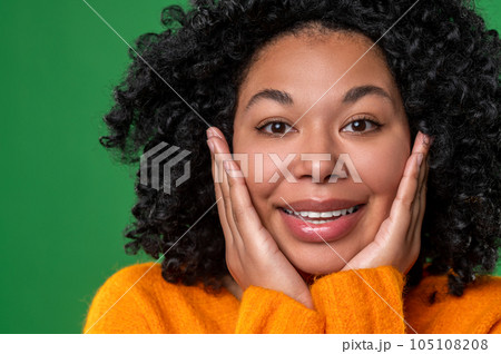Happy dark-haired ypung woman in orange Happy dark-haired ypung woman in orange 105108208