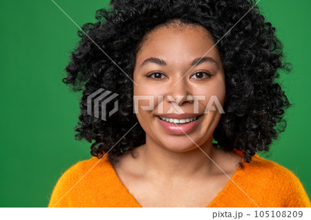Happy dark-haired ypung woman in orange Happy dark-haired ypung woman in orange 105108209