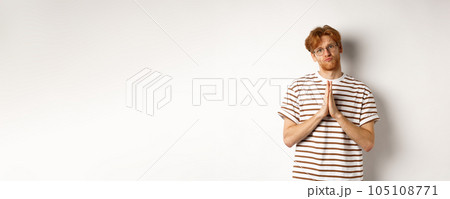 Silly redhead man asking for help, holding hands in pleading gesture and pucker lips, say please while begging you, standing over white background Silly redhead man asking for help, holding hands in pleading gesture and pucker lips, say please while begging you, standing over white background 105108771