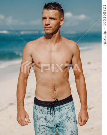 Handsome slim man enjoying day on the summer beach. 105108821