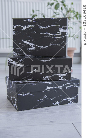 Blank black cardboard boxes for good and gifts. boxes for packaging goods from stores.festive packages Blank black cardboard boxes for good and gifts. boxes for packaging goods from stores.festive packages 105109410