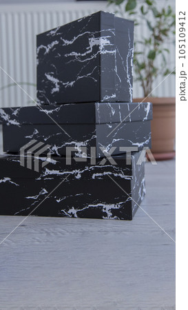 Blank black cardboard boxes for good and gifts. boxes for packaging goods from stores.festive packages Blank black cardboard boxes for good and gifts. boxes for packaging goods from stores.festive packages 105109412