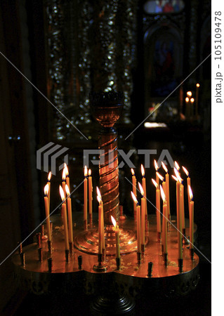 church candles burning in candlesticks in darkness church candles burning in candlesticks in darkness 105109478