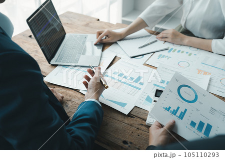 startup Asian business advisor meeting to analyze and discuss the situation on the financial report in the meeting room. 105110293