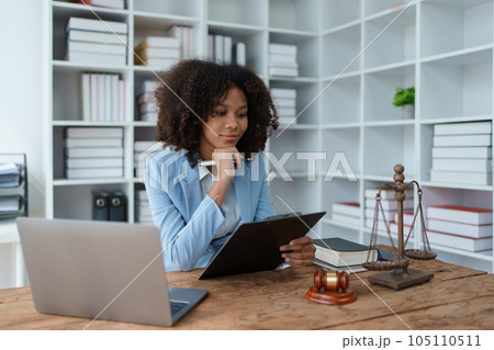 A young women African American lawyer lawsuit studying cases for clients in a law firm to fight against their parties in the courts. law and attorney concepts 105110511