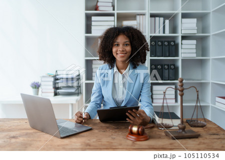 A young women African American lawyer lawsuit studying cases for clients in a law firm to fight against their parties in the courts. law and attorney concepts 105110534