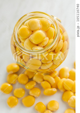 Lupini beans in brine. Pickled lupin in jar on kitchen table. Lupini beans in brine. Pickled lupin in jar on kitchen table. 105110740