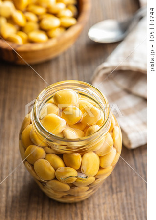 Lupini beans in brine. Pickled lupin in jar on kitchen table. Lupini beans in brine. Pickled lupin in jar on kitchen table. 105110744