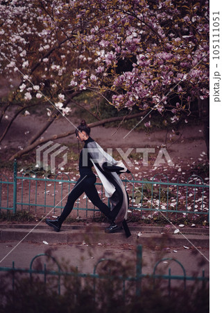 Beautiful young woman wearing kimono with cherry blossoms, sakura view Beautiful young woman wearing kimono with cherry blossoms, sakura view 105111051