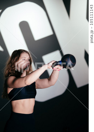 Athletic Beautiful Woman Does her cross fitness at gym 105111143