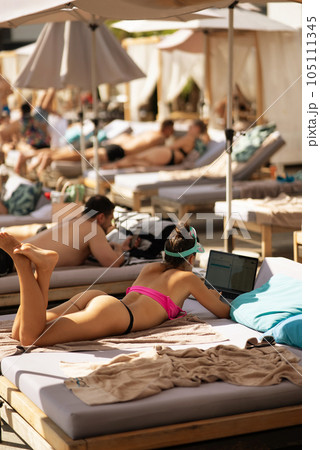 beautiful girl in bikini sunbathing on the beach 105111345