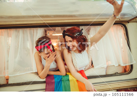 Portrait of a cute lesbian couple. Two girls spend time tenderly together in a camper trailer. Love and attitude. LGBT concept Portrait of a cute lesbian couple. Two girls spend time tenderly together in a camper trailer. Love and attitude. LGBT concept 105111566