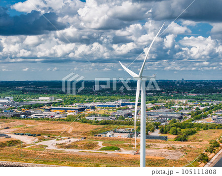 Aerial view of the wind turbines. Green ecological power energy generation. Wind farm eco field. Offshore and onshore windmill farm green energy at sea. Offshore wind turbines on the coast of Copenhag 105111808