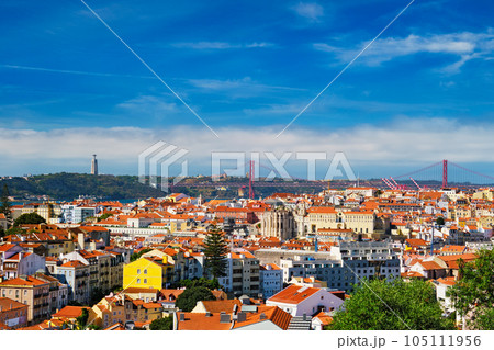 Lisbon famous view from Miradouro dos Barros tourist viewpoint over Alfama old city district, 25th of April Bridge and Christ the King statue. Lisbon, Portugal. With copyspace Lisbon famous view from Miradouro dos Barros tourist viewpoint over Alfama old city district, 25th of April Bridge and Christ the King statue. Lisbon, Portugal. With copyspace 105111956