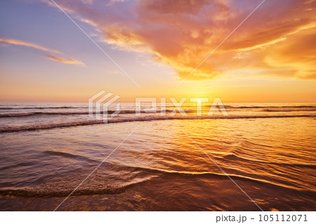 Atlantic ocean sunset with surging waves at Fonte da Telha beach, Costa da Caparica, Portugal 105112071