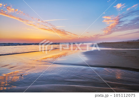 Atlantic ocean after sunset with surging waves at Fonte da Telha beach, Costa da Caparica, Portugal 105112075