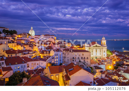 View of Lisbon famous view from Miradouro de Santa Luzia tourist viewpoint over Alfama old city district at night. Lisbon, Portugal. 105112076