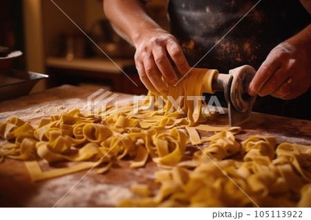hand-cutting pasta dough into tagliatelle, created with generative ai hand-cutting pasta dough into tagliatelle, created with generative ai 105113922