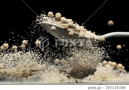 White Pepper seeds fly explosion, white Pepper mix powder float explode, abstract cloud fly. Peppercorn mix powder splash throwing in Air. Black background Isolated selective focus blur 105116386