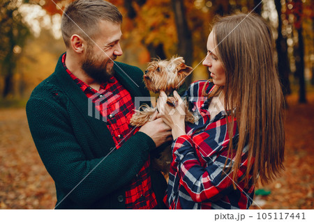 Couple in a park. Family in a golden forest. Man with a dog Couple in a park. Family in a golden forest. Man with a dog 105117441