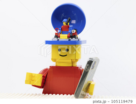 giant man use the phone, at the same time the mini one also using the phone as like as him 105119479