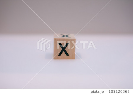Wooden block written "X" with a white background, education concept, close-up. Wooden block written "X" with a white background, education concept, close-up. 105120365