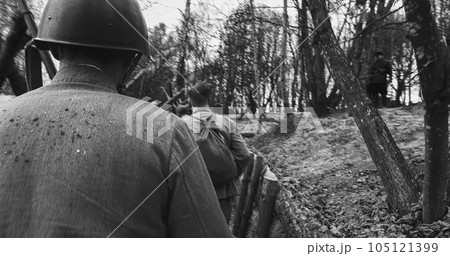 Re-enactors Dressed As Soviet Russian Soldiers take up fighting positions in trenches. Position Defense. Soldiers Aiming With Rifles. Reconstruction Of Battles World War Ii. Black And White Re-enactors Dressed As Soviet Russian Soldiers take up fighting positions in trenches. Position Defense. Soldiers Aiming With Rifles. Reconstruction Of Battles World War Ii. Black And White 105121399