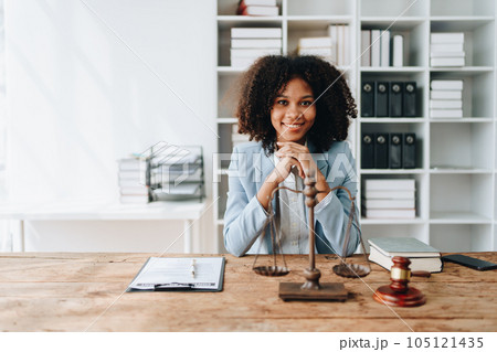 A young women African American lawyer lawsuit studying cases for clients in a law firm to fight against their parties in the courts. law and attorney concepts A young women African American lawyer lawsuit studying cases for clients in a law firm to fight against their parties in the courts. law and attorney concepts 105121435