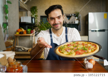 Man baking a pizza. Man baking a pizza. 105122715