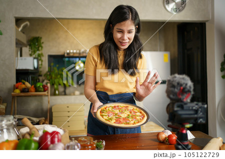 Woman baking a pizza. Woman baking a pizza. 105122729
