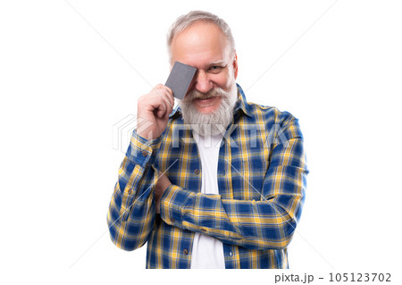 handsome 60s middle aged gray-haired man with a beard holding a plastic card on a white background 105123702
