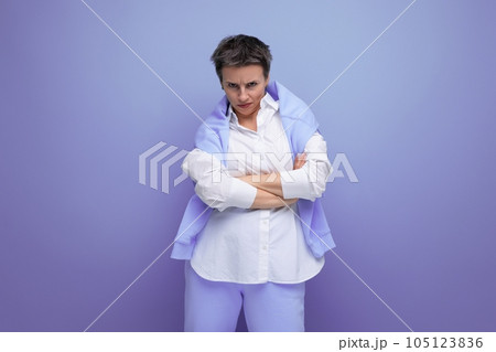 upset pensive young dark-haired woman with a short haircut in a white shirt upset pensive young dark-haired woman with a short haircut in a white shirt 105123836