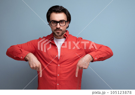 handsome caucasian brunette 30s male manager in a red shirt reports a promotional offer hanging on handsome caucasian brunette 30s male manager in a red shirt reports a promotional offer hanging on 105123878