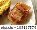 Breakfast dish. Open-Faced Sandwich  - Smoked ham with honey on toasted bread. 105127574