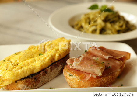 Breakfast set. Delicious sandwich - omelette and smoked ham with honey  on toasted bread. 105127575