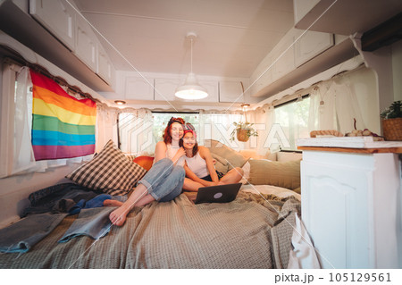 Portrait of a cute lesbian couple. Two girls spend time tenderly together in a camper trailer. Love and attitude. LGBT concept 105129561
