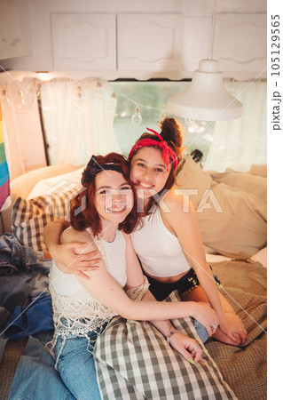 Portrait of a cute lesbian couple. Two girls spend time tenderly together in a camper trailer. Love and attitude. LGBT concept 105129565