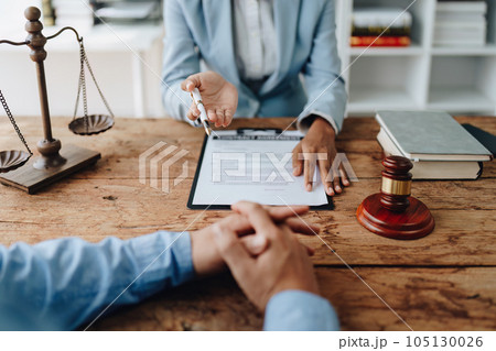 african american attorney, lawyers discussing contract or business agreement at law firm office, Business people making deal document legal, justice advice service concepts. african american attorney, lawyers discussing contract or business agreement at law firm office, Business people making deal document legal, justice advice service concepts. 105130026