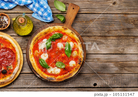 Margarita pizza with tomatoes, mozzarella cheese and basil Margarita pizza with tomatoes, mozzarella cheese and basil 105131547