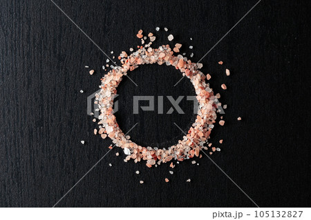 Pink salt on a black ceramic table. 105132827