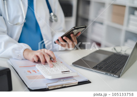 Doctor working in hospital use calculator, Healthcare and medical concept. 105133758