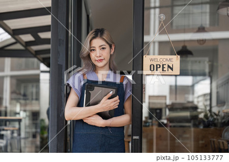 Coffee shop owner looking confident smiling at camera with arms crossed. Positive business concept Coffee shop owner looking confident smiling at camera with arms crossed. Positive business concept 105133777